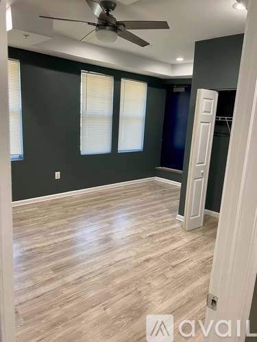 A room with a ceiling fan and lighting fixtures.