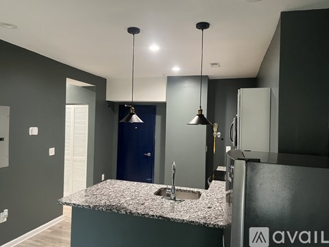 A kitchen with granite countertops and a sink.