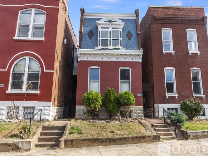 A red brick house with a blue diamond patterned window.