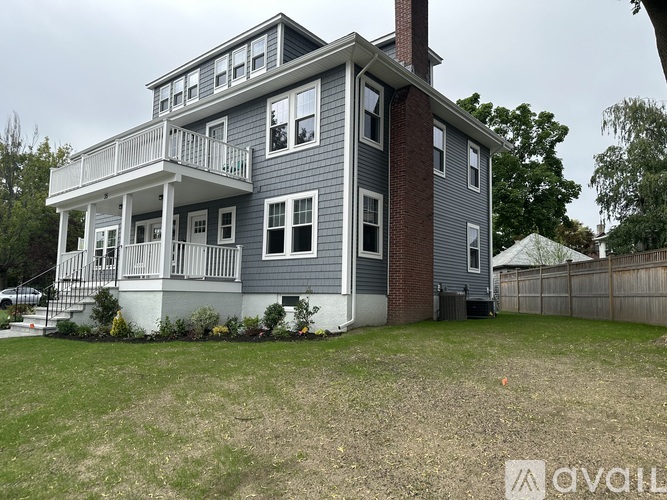 A two-story house with a balcony on the second floor.