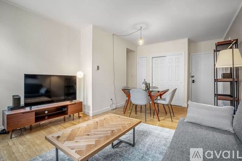A living room with a wooden coffee table and a television.