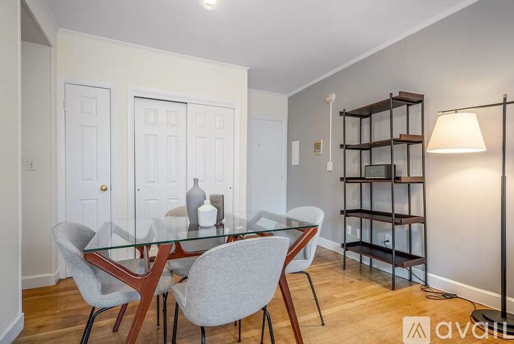 A dining room with a glass table and chairs.