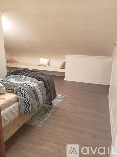 A bedroom with a bed and a bench.