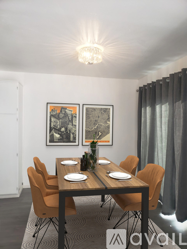 A dining room with a wooden table and chairs.