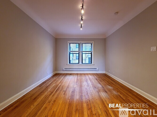 A room with wooden floors and a window.
