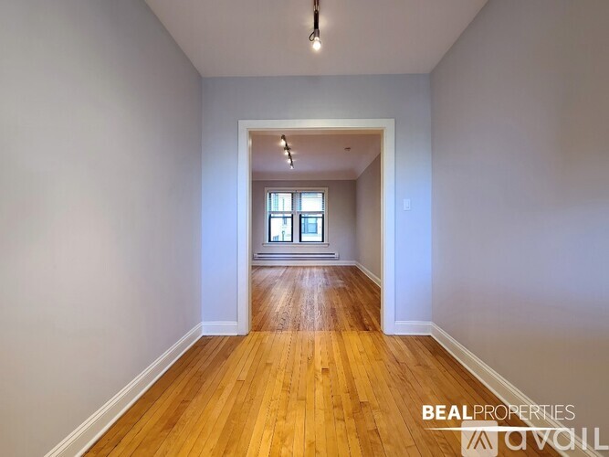 A room with wooden floors and a window.