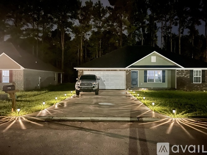 A house with a driveway and a car parked in front.