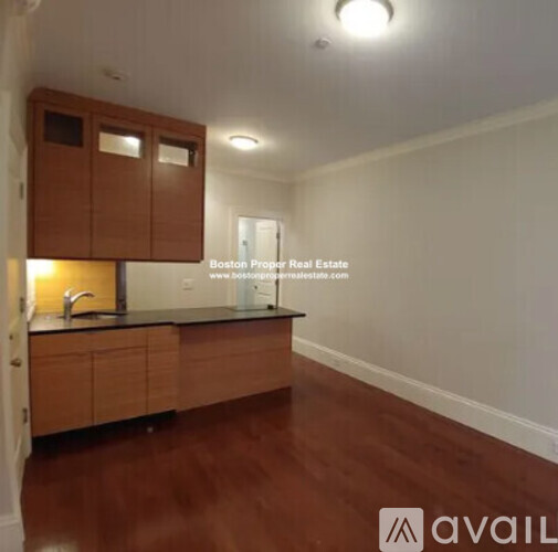 A kitchen with wooden cabinets and a countertop.