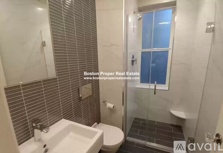A bathroom with a sink, toilet, and shower.