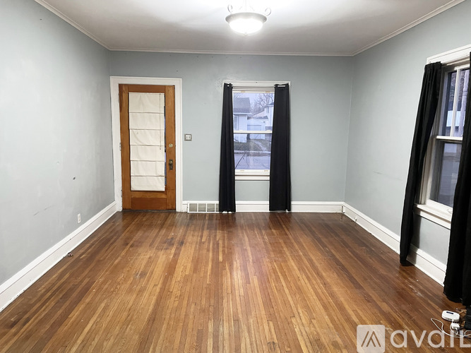 A room with wooden floors and a door.