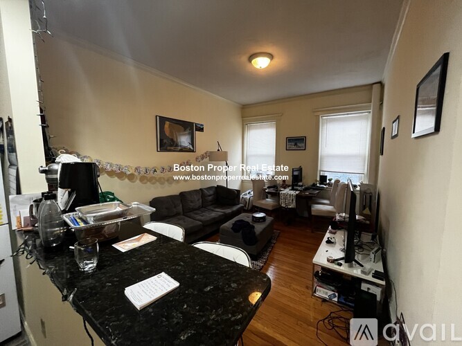 A living room with a black granite countertop and a sofa.