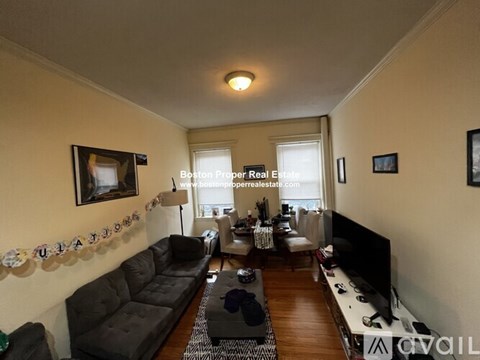 A living room with a grey couch and a television.