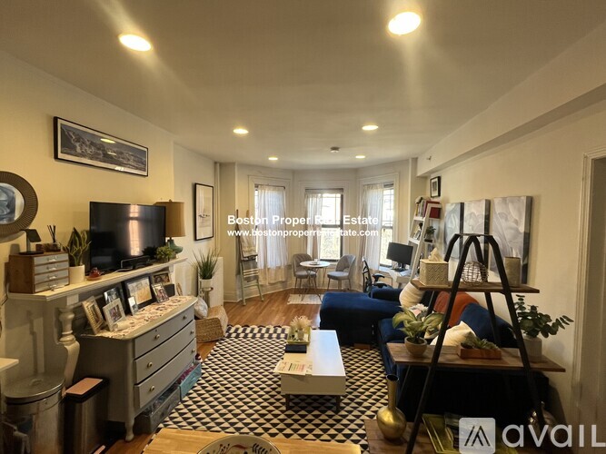 A living room with a television, a couch, and a coffee table.