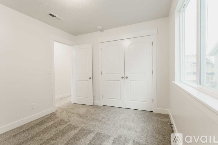 A room with two white doors and a carpeted floor.
