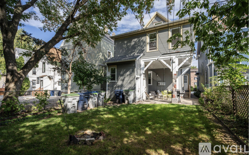 A house with a well-kept lawn and trees in the front yard.