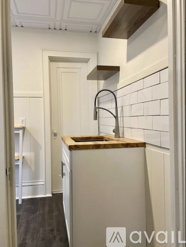 A kitchen with a white refrigerator and a wooden countertop.