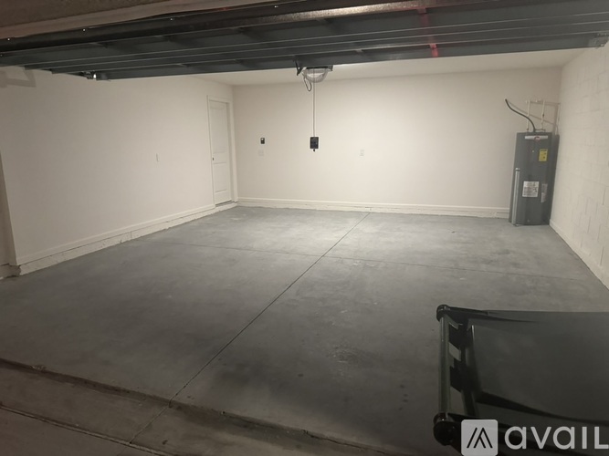 A spacious garage with a concrete floor and a metal support beam.