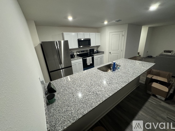 A kitchen with granite countertops and stainless steel appliances.