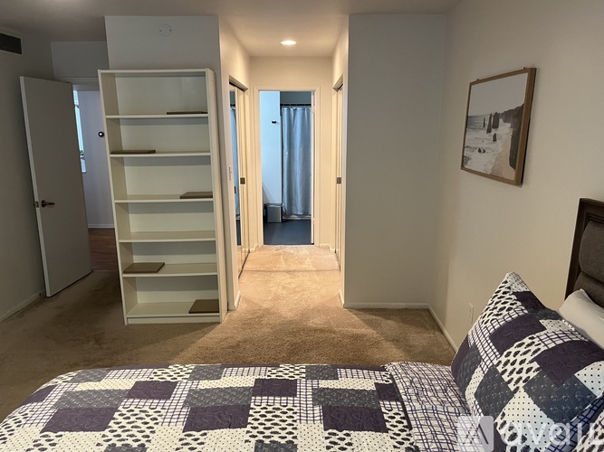 A bedroom with a bed and a wardrobe.