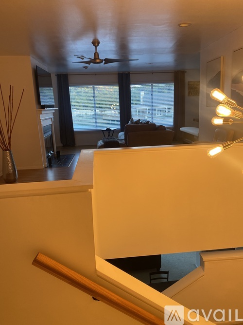 A living room with a couch and a ceiling fan.