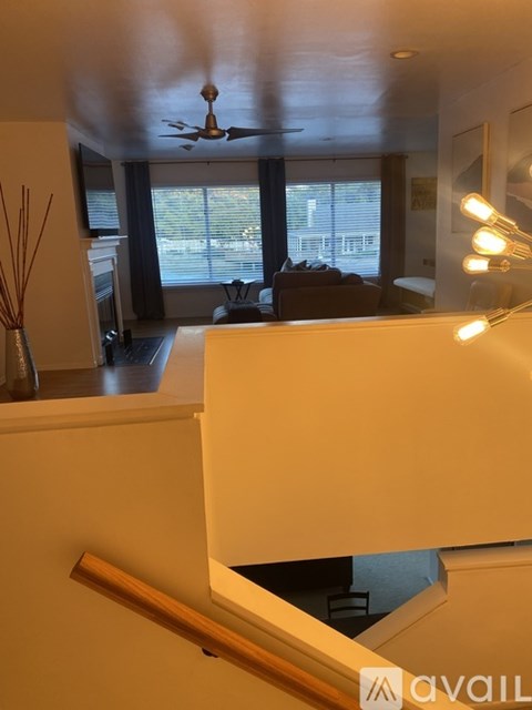 A living room with a couch and a ceiling fan.