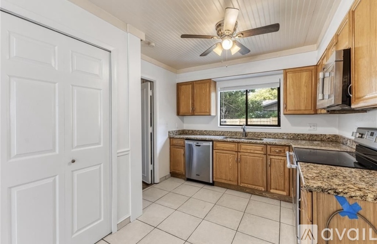 A kitchen with wooden cabinets and a white door.