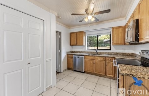 A kitchen with wooden cabinets and a white door.