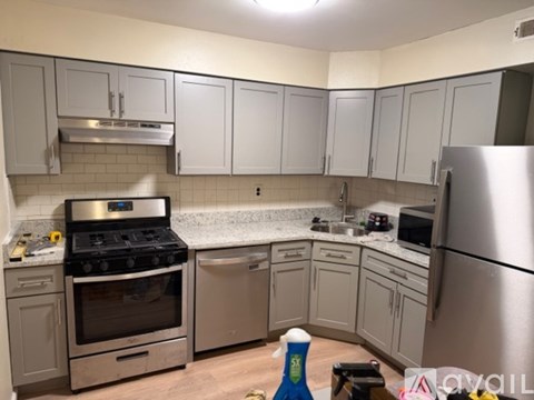 A kitchen with a stove, oven, dishwasher, and refrigerator.