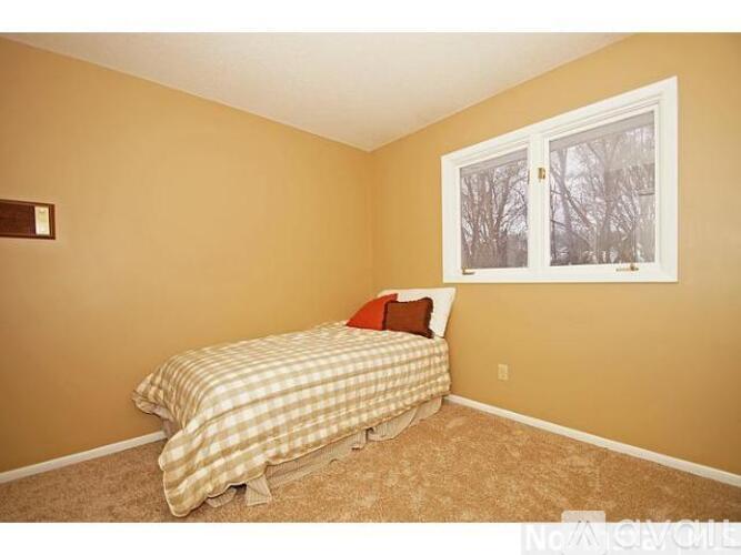 A bedroom with a bed and a window.