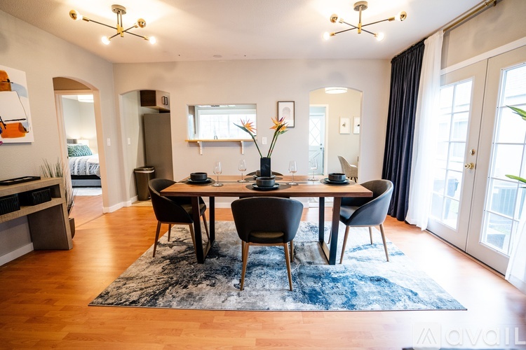 A dining room with a table set for four.