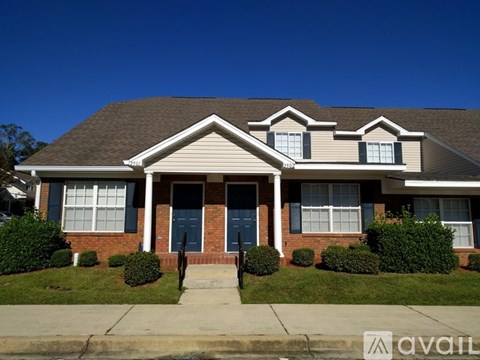 A house with a "For Rent" sign in front.