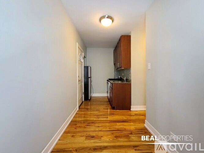 A BEALPROPERTIES sign is on a wall in a kitchen.