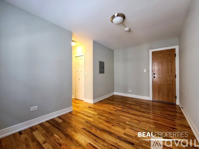 A room with wooden floors and a white door.