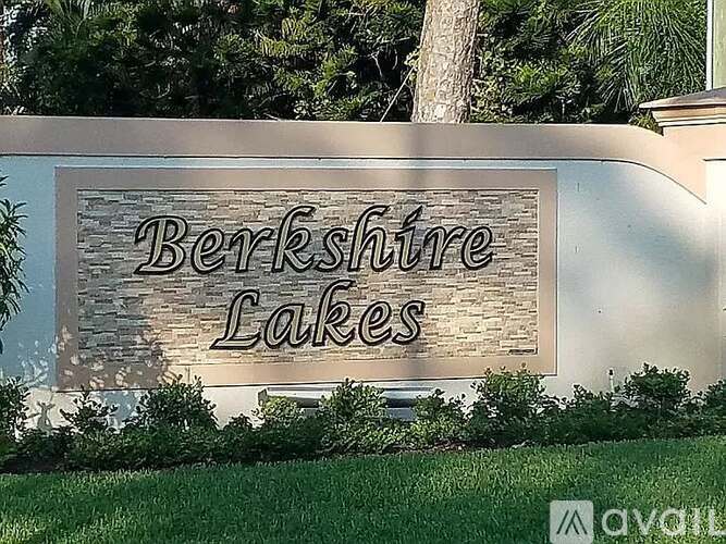 A sign that says Berkshire Lakes in front of some trees.