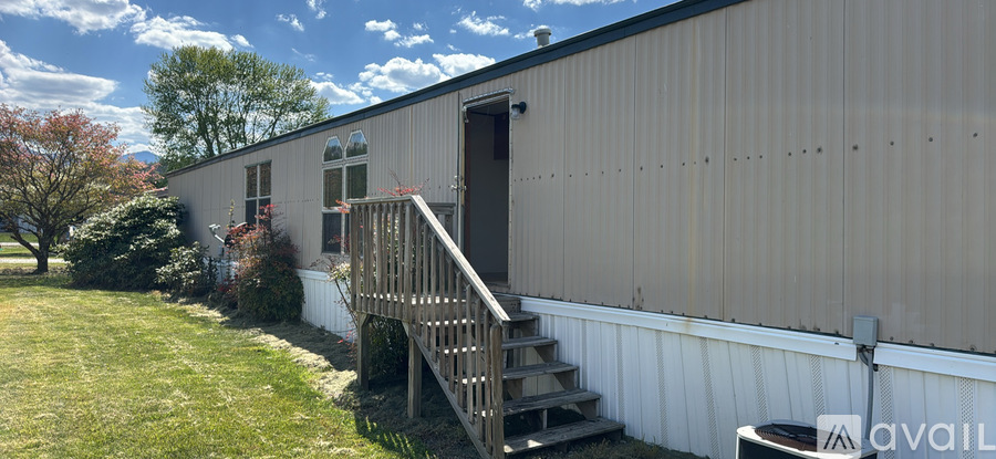 A house with a white exterior and a brown door.