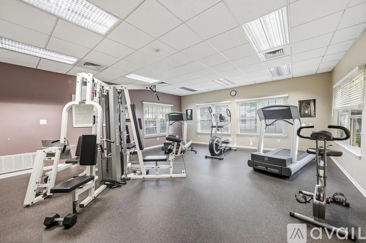 A well-equipped gym with a variety of exercise machines and weights.