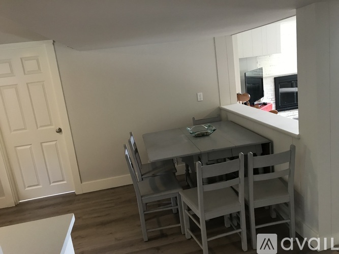 A dining room with a table and chairs.