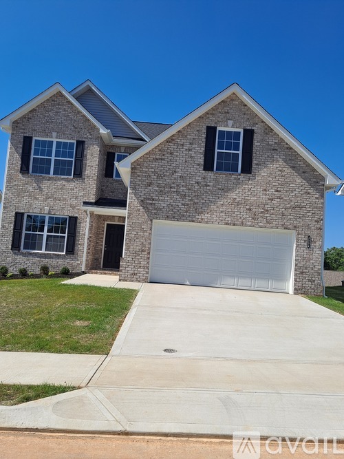 A two-story house with a garage is for sale.