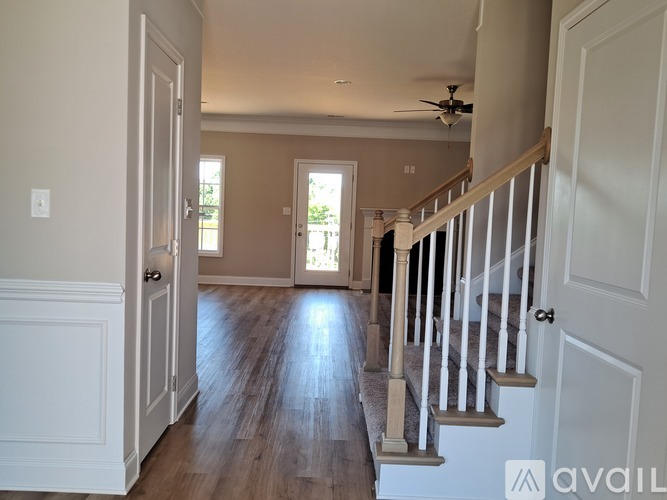 A spacious hallway with a staircase leading to the second floor.