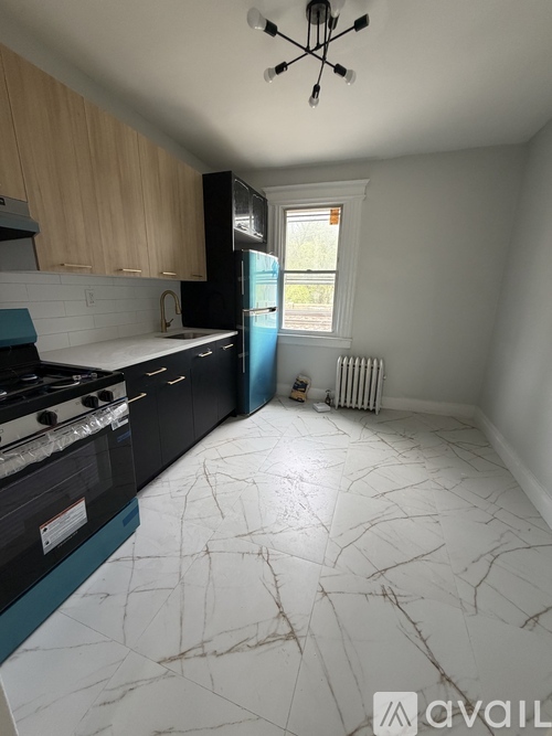 A kitchen with a black stove top oven and a black fridge.