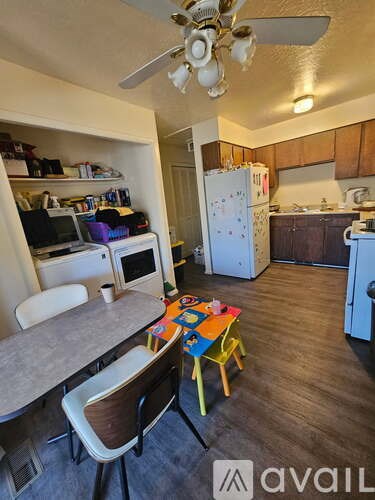A kitchen with a table and chairs in the middle of the room.