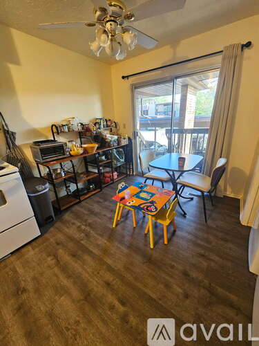 A kitchen with a dining table and chairs in the middle of the room.