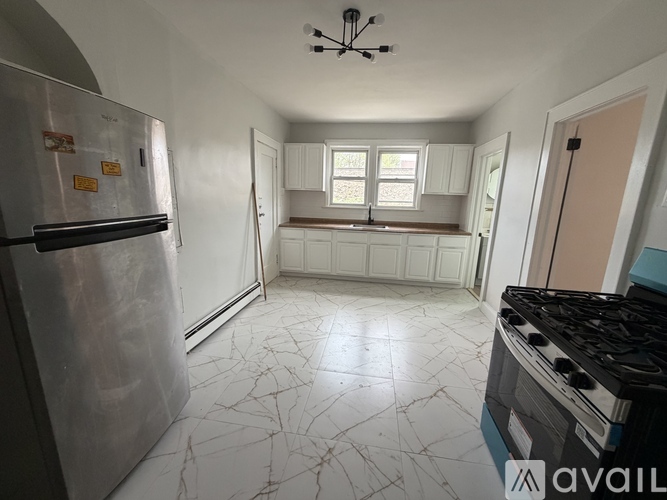 A kitchen with a stove and a refrigerator.