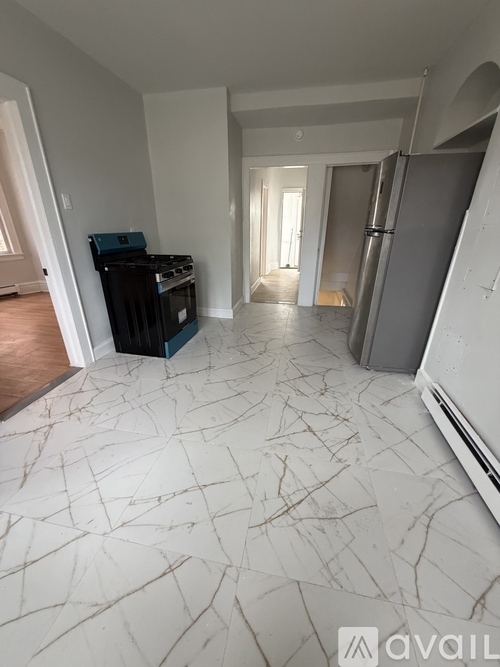 A room with a white marble floor and a black piano.
