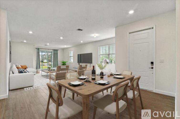 A dining room with a wooden table and chairs.