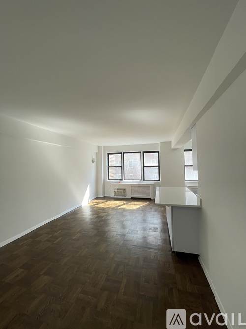 A room with wooden floors and white walls.