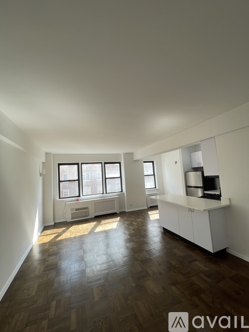 A room with wooden floors and white walls.
