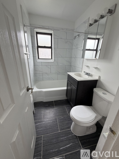A bathroom with a toilet, sink, and bathtub.