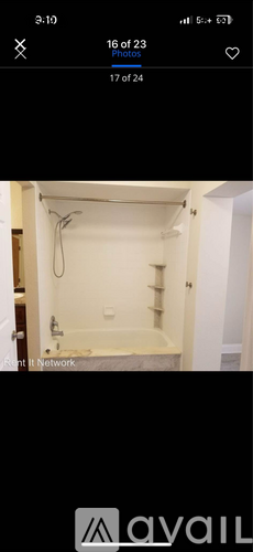 A white bathroom with a bathtub and a shower.