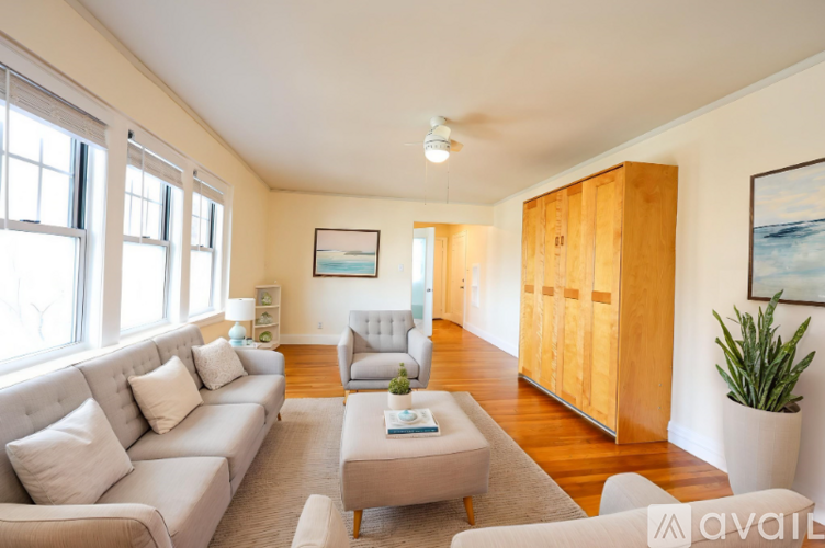 A living room with a couch, armchair, and a coffee table.
